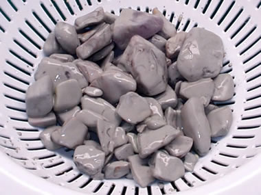 Muddy rocks in collander after coarse grind